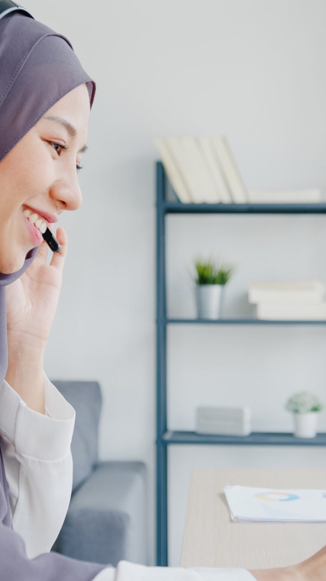 Asia muslim lady wear headphone watch webinar listen online cour Asia muslim lady wear headphone watch webinar listen online course communicate by conference video call at house. Remotely working from home, social distancing, quarantine for corona virus prevention.